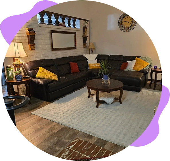 Living room with leather sectional and rug.