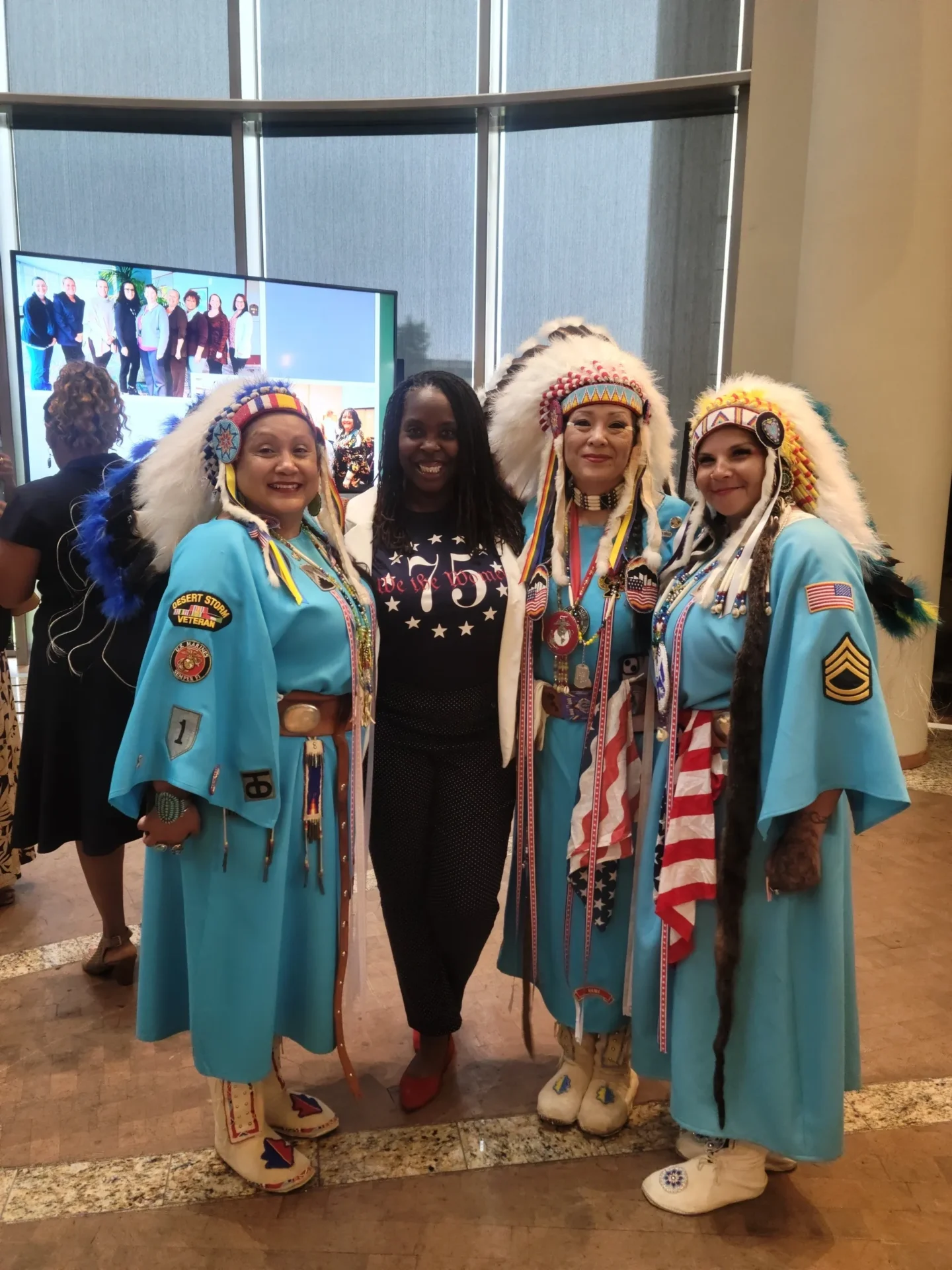 Three women in traditional Native American dress.