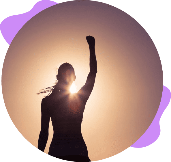 Silhouette of a woman raising her fist in the air.