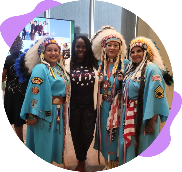 Four women in traditional Native American dress.